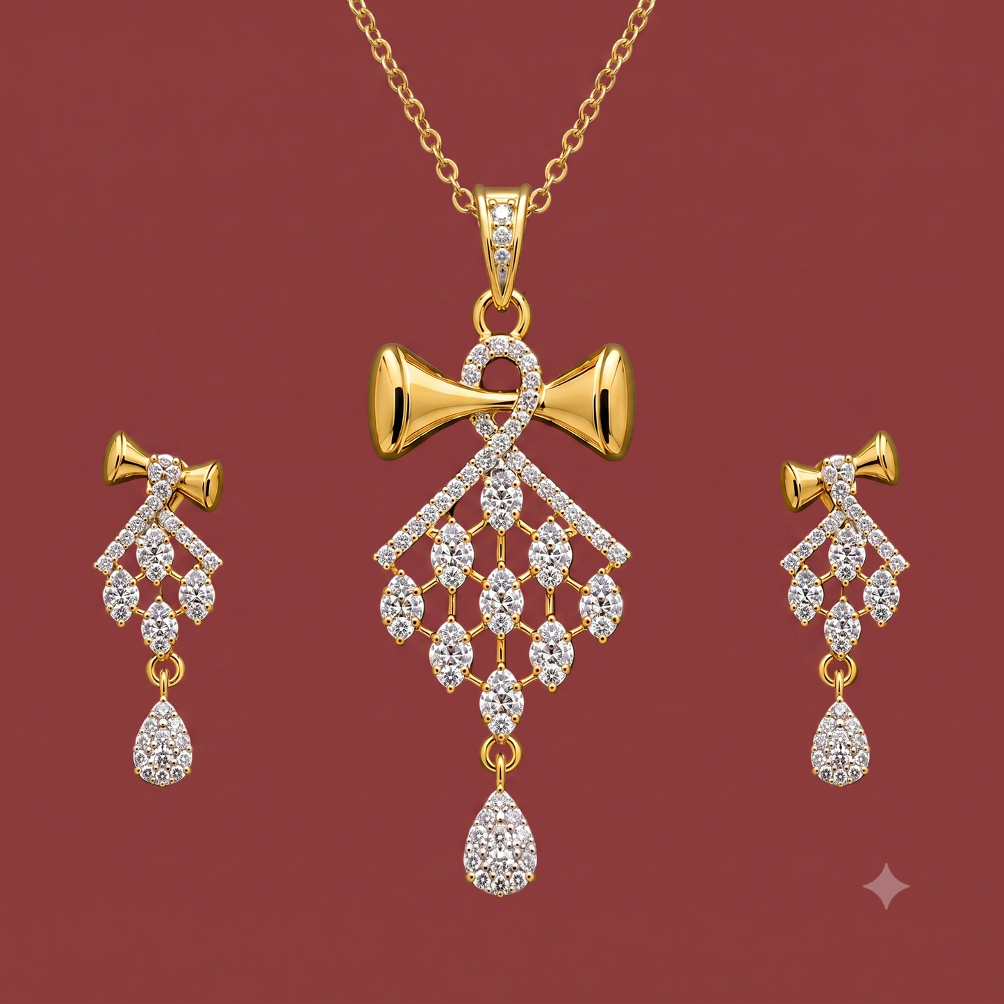 Gold-tone American Diamond bow pendant set with matching drop earrings on a dark red background.