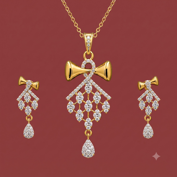 Gold-tone American Diamond bow pendant set with matching drop earrings on a dark red background.