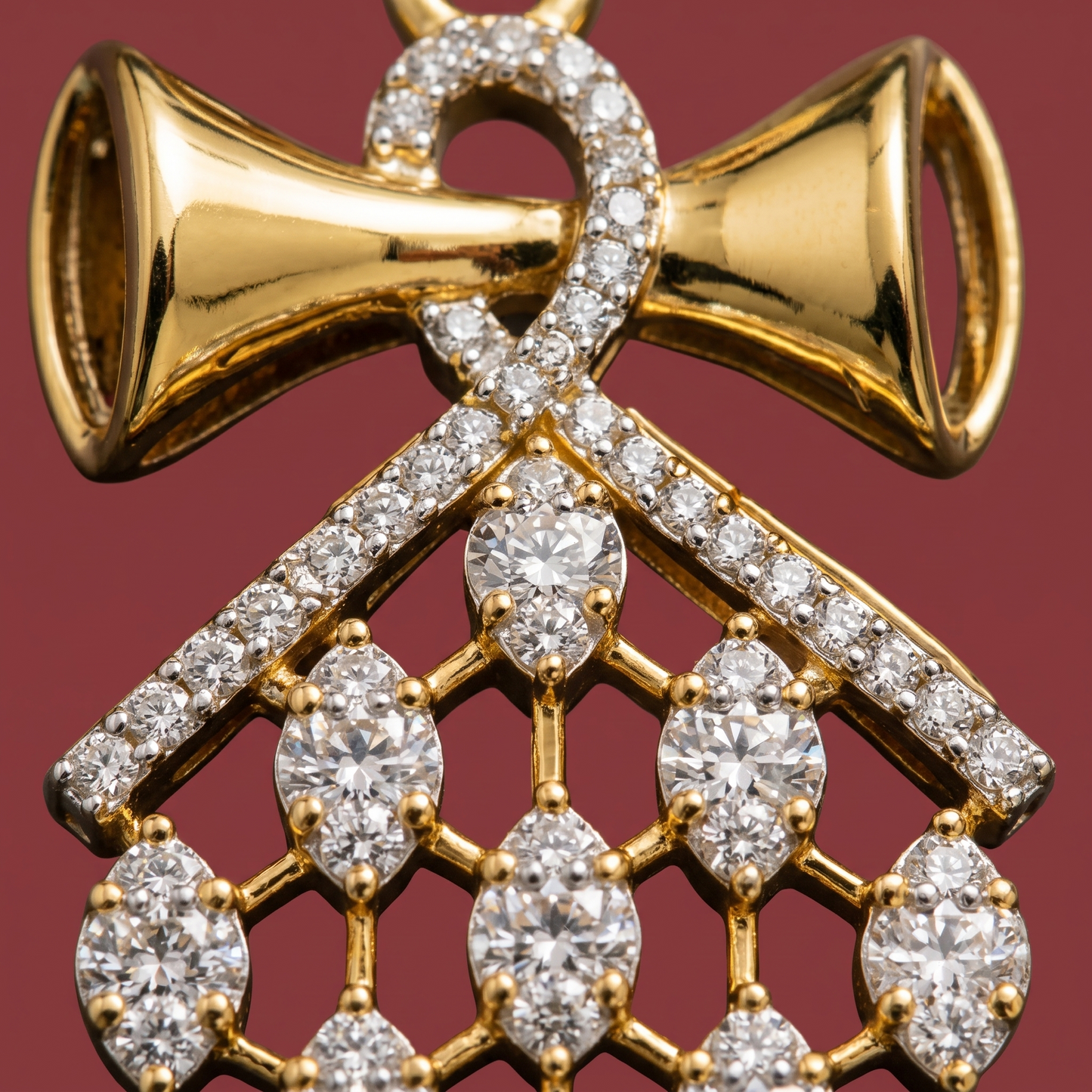 Close-up macro shot of an American Diamond bow pendant showing intricate detailing and gold-tone chain.